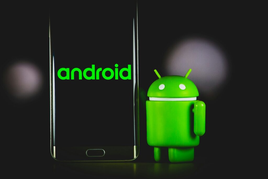 What is the cost of Android App in Kenya ? 3 green frog iphone case beside black samsung android smartphone