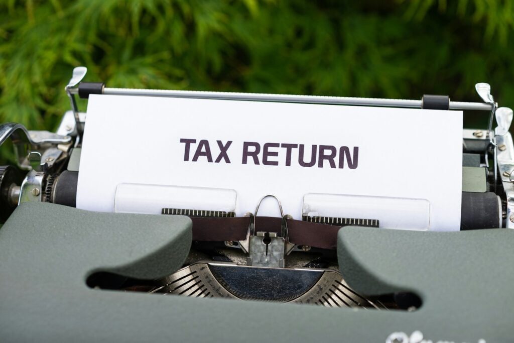 What is eTims ? ,The New KRA Invoicing System in Kenya , Requirements , Benefits ,Sign Up and Installation 1 a close up of a typewriter with a tax return sign on it