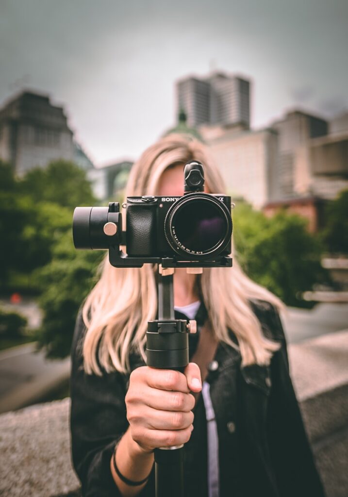 Video & Animation Service 1 selective focus photography of woman holding camera gimbal