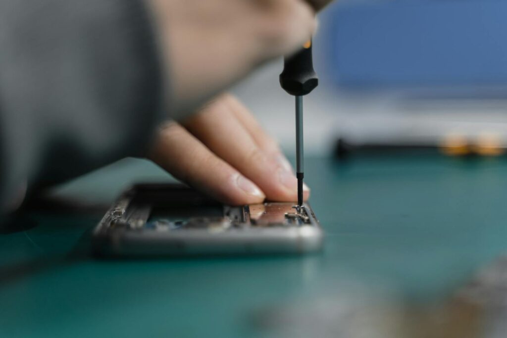 How to Register Your E-commerce Business in Kenya (eCitizen Guide) 1 Detailed shot of smartphone repair with a screwdriver and hand close-up.