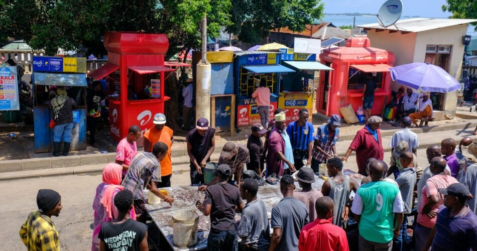 a crowd of people standing around a street vendor
