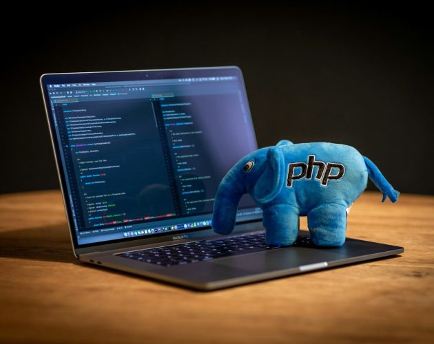 blue elephant plush toy on black laptop computer